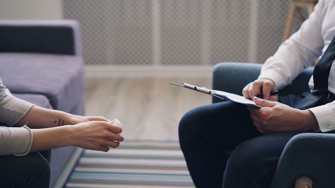 two people sitting facing each other going over information